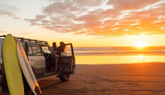 People on beach enjoying a beautiful sunset